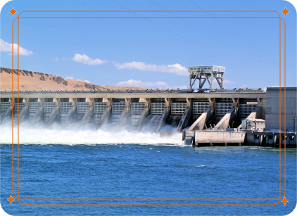 Spillways at a large hydro-electric dam eject water into a lake
