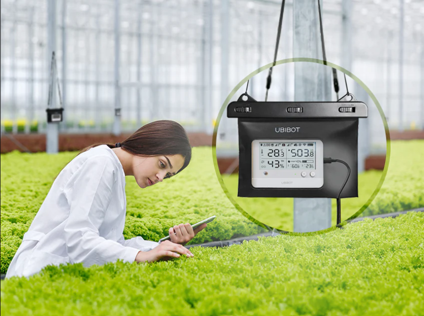 Ws1-pro wifi wireless data logger in a water resistant case in a greenhouse with a person tending to the plants; smart data loggers