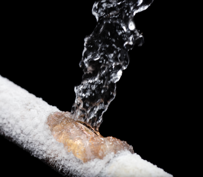 A frozen water pipe with water coming out of it. Prevent frozen water pipes